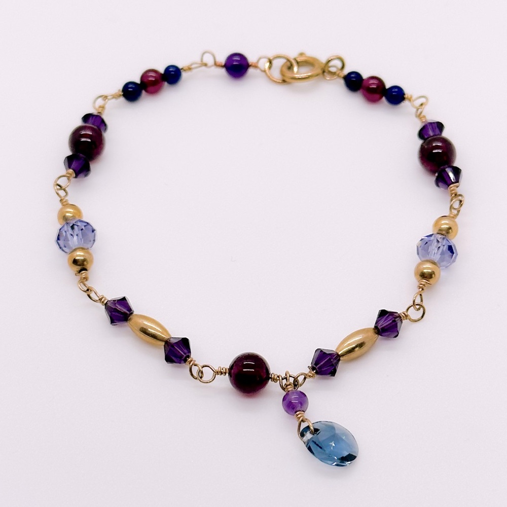 Handmade Bracelet with Swarovski crystals, garnets, goldfill and other beads.